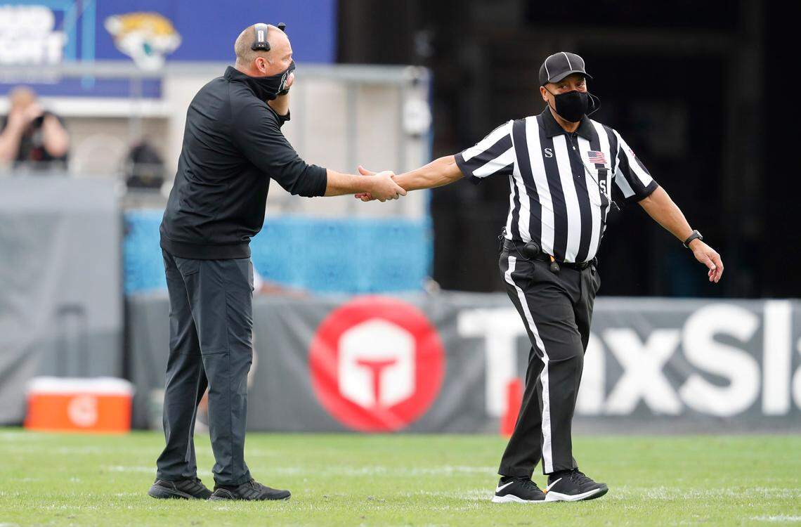 N.C. State head coach Dave Doeren talks with an official during the second half of Kentucky’s 23-21 victory over N.C. State in the Gator Bowl at TIAA Bank Field in Jacksonville, Fla., Saturday, January 2, 2021.