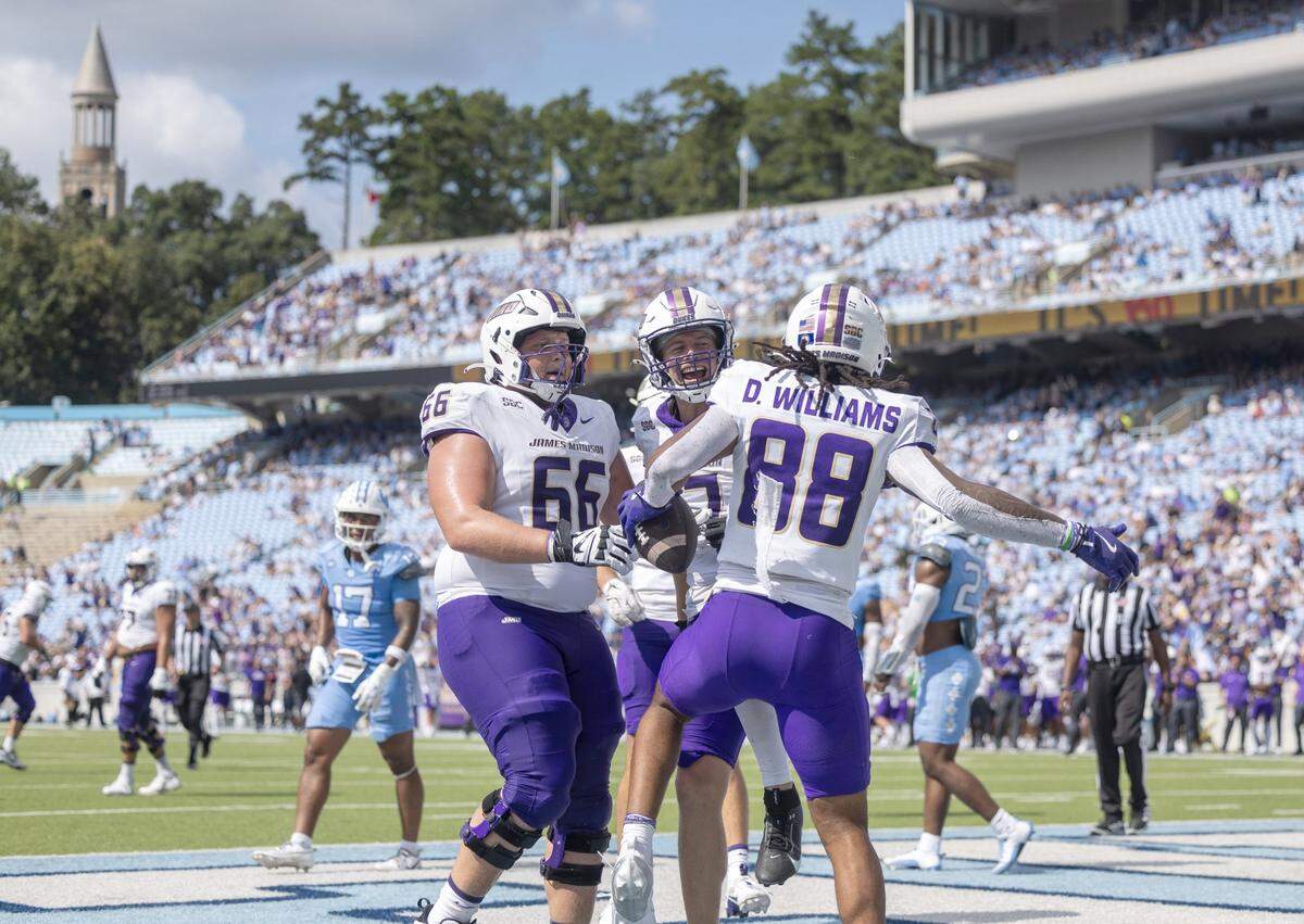 James Madison wide receiver Dylan Williams (88) celebrates with teammates Tyler Thompson (17) and Cole Potts (66), after scoring a touchdown on a seven-yard pass completion from quarterback Alonza Barnett III, to give the Dukes a 60-24 lead over North Carolina in the third quarter on Saturday, September 21, 2024 at Kenan Stadium in Chapel Hill, N.C.