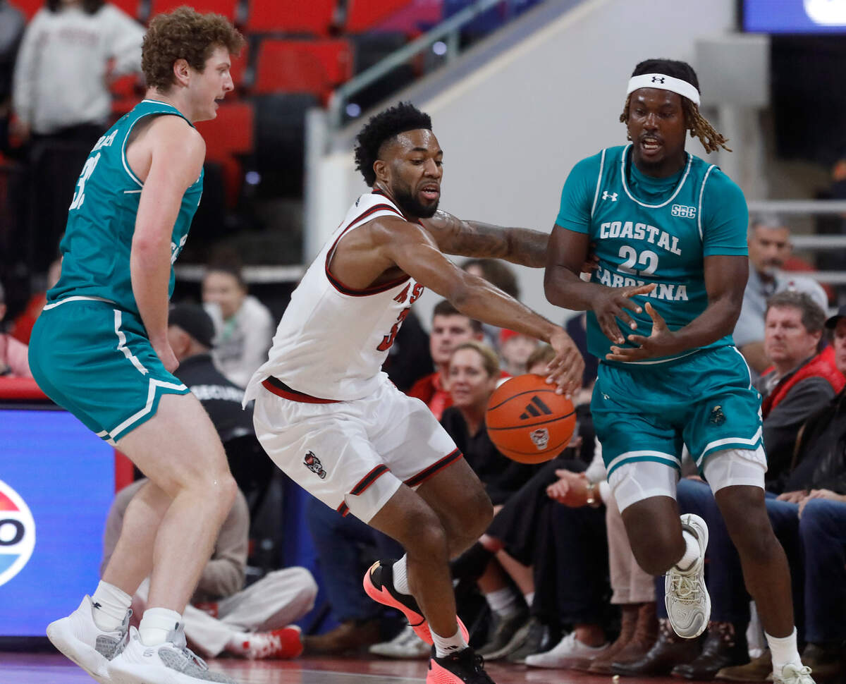 N.C. State’s Dontrez Styles steals the ball from Coastal Carolina’s Denzel Hines (22) during the first half of the Wolfpack’s 82-70 win on Wednesday, Nov. 13, 2024, at Lenovo Center in Raleigh, N.C.
