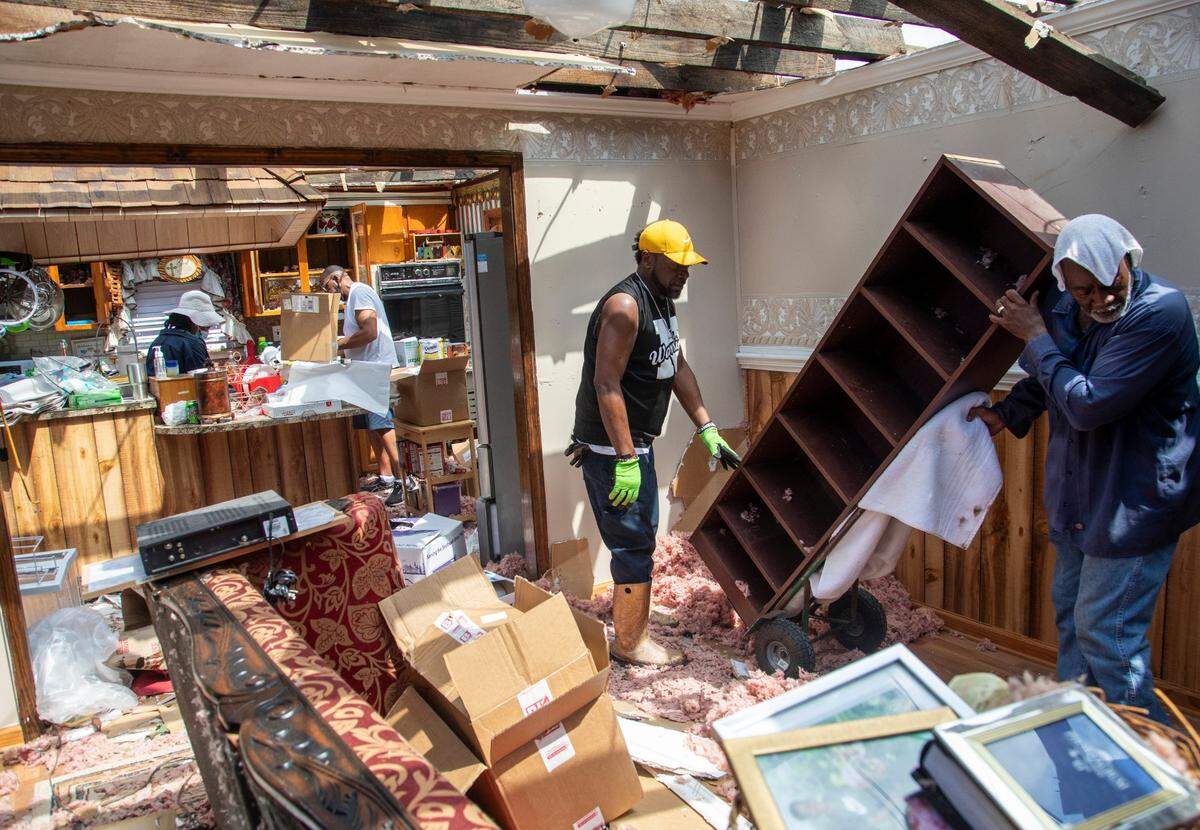 Family members help clean up the home of Evelyn Powell, an Edgecombe County Commissioner, Thursday, July 20, 2023 in Battleboro. An EF3, tornado with wind speeds of 150 mph touched down in Nash and Edgecombe Counties around 12:30 p.m. Wednesday according to the Raleigh National Weather Service.