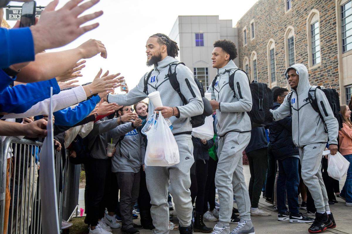 From left, Duke’s Theo John, Paolo Banchero and Jeremy Roach prepare to depart for the Final Four in New Orleans Tuesday, March 29, 2022 outside Cameron Indoor Stadium.
