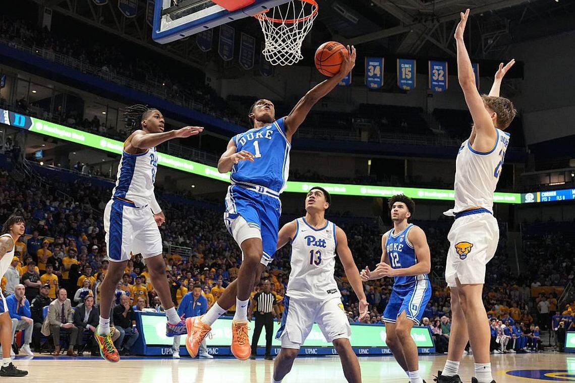 PITTSBURGH, PA - FEBRUARY 10:  Caleb Foster #1 of the Duke Blue Devils goes up for a shot against Omari Witherspoon #8 and Nojus Indrusaitis #25 of the Pittsburgh Panthers in the first half at the Petersen Events Center on February 10, 2026 in Pittsburgh, Pennsylvania.  (Photo by Mitchell Layton/Getty Images)