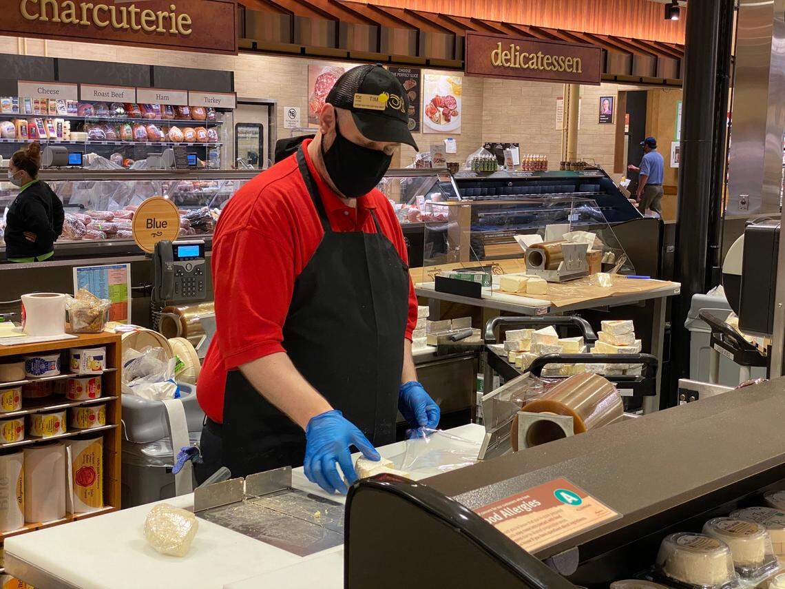 Tim Lazaroff works in the West Cary Wegmans cheese shop on July 27, 2020. The grocery store opens its newest location on Davis Drive on July 29, 2020.