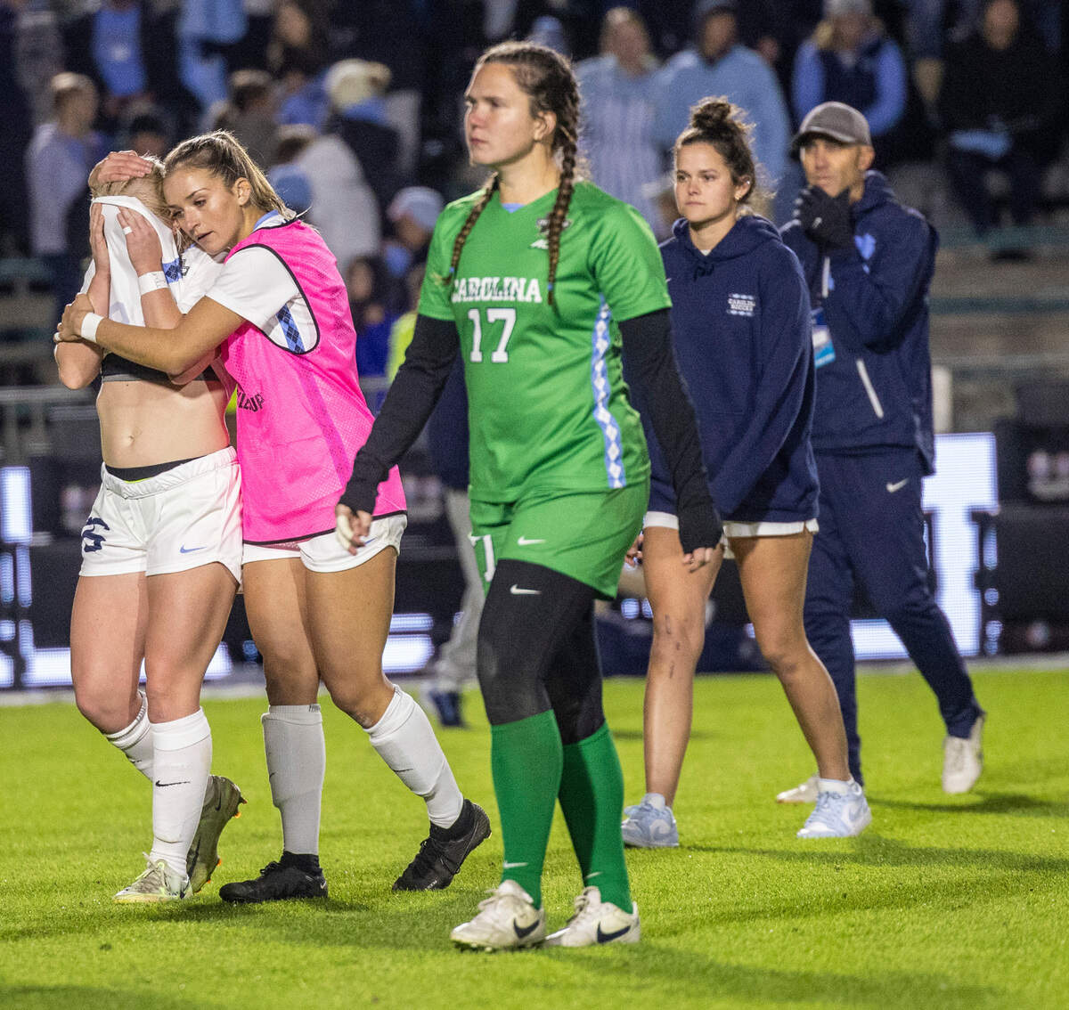 Dejected UNC players comfort each other after losing 3-2 in overtime against UCLA during the NCAA Division I Championship at WakeMed Soccer Park in Cary Monday, Dec. 5, 2022.