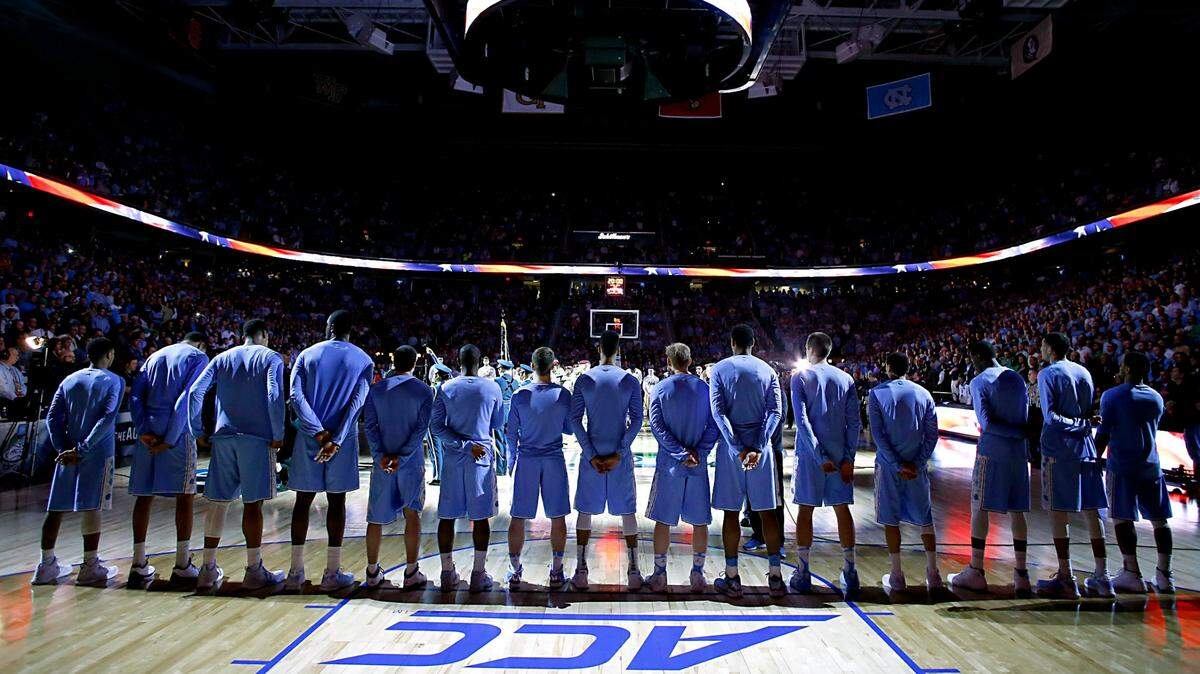 UNC players line up for the playing of the National Anthem before North Carolina’s game against Notre Dame in the finals of the 2015 New York Life ACC Tournament at the Greensboro Coliseum in Greensboro, N.C., Saturday, March 14, 2015.