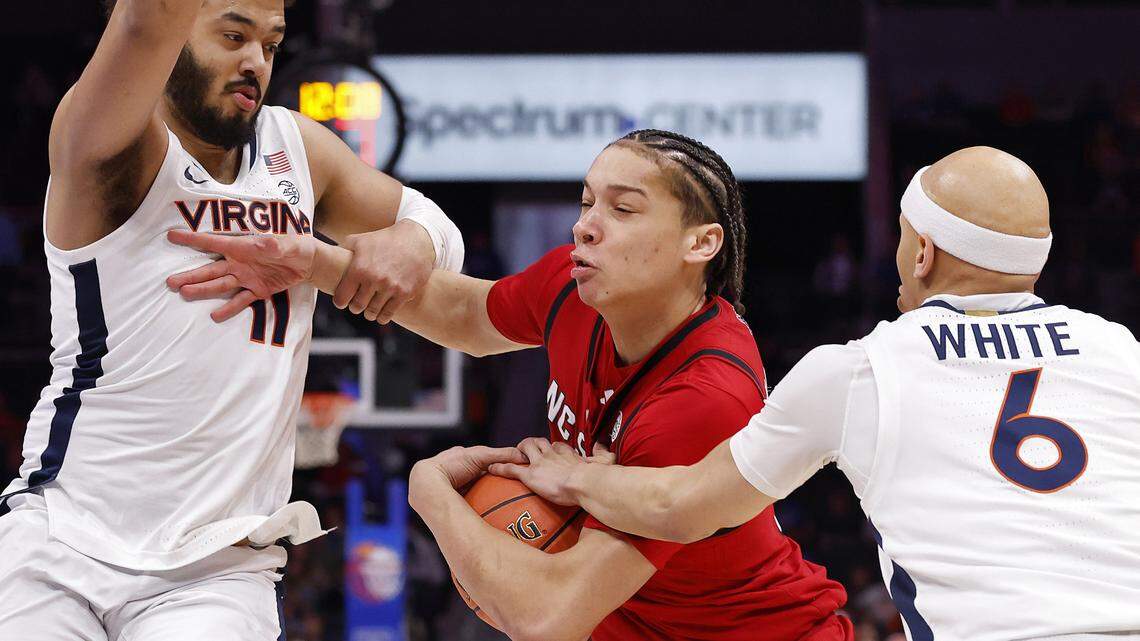 N.C. State’s Matt Able drives between Virginia's Devin Tillis and Jacari White during the first half of the Wolfpack’s ACC Tournament quarterfinal game on Thursday, March 12, 2026, at the Spectrum Center in Charlotte, N.C. 