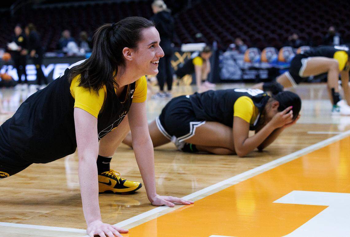 Iowa’s Caitlin Clark smiles while stretching during practice at Rocket Mortgage FieldHouse on Thursday, April 4, 2024, in Cleveland, Ohio. The Hawkeyes will face UConn in the Final Four on Friday.