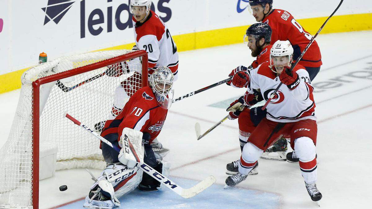 Apr 24, 2019; Washington, DC, USA; Carolina Hurricanes left wing Brock McGinn (23) celebrates after scoring the game-winning goal on Washington Capitals goaltender Braden Holtby (70) in the second overtime in game seven of the first round of the 2019 Stanley Cup Playoffs at Capital One Arena.