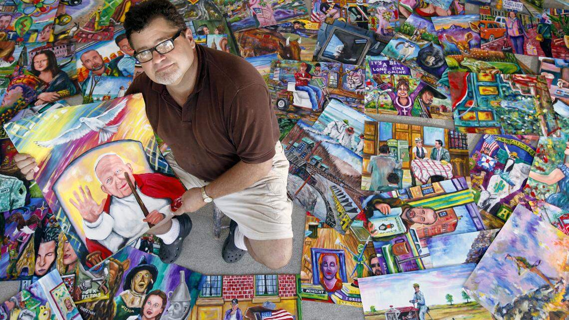 Will Hinton, professor of art with Louisburg College, has retired after 40 years. He stands here with 130 paintings from an inmate in Pennsylvania serving life for murder.