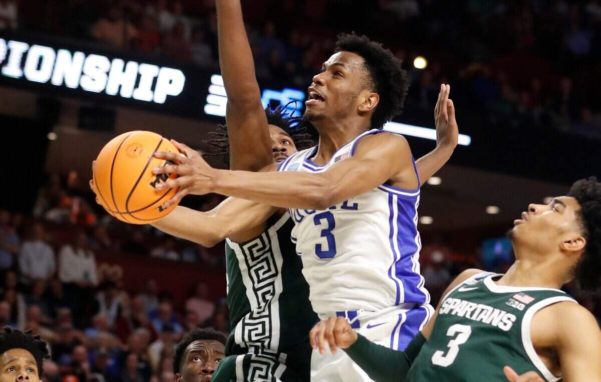 Dukes Jeremy Roach (3) heads to the basket while being fouled during the first half of Dukes game against Michigan State in the second round of the NCAA Tournament at Bon Secours Wellness Arena in Greenville, S.C., Sunday, March 20, 2022.