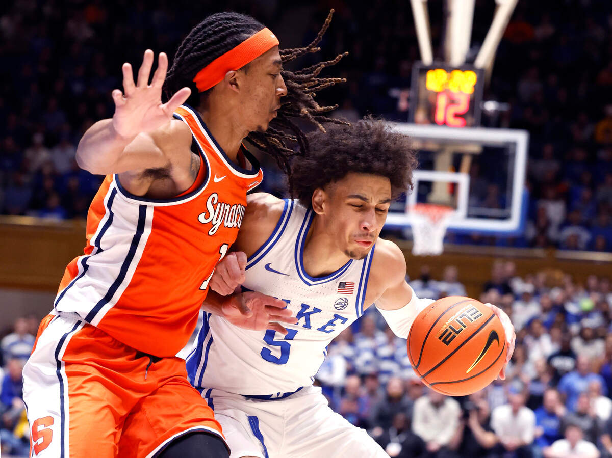 Duke’s Tyrese Proctor (5) is defended by Syracuse’s Maliq Brown (1) during the second half of Duke’s 86-66 victory over Syracuse at Cameron Indoor Stadium in Durham, N.C., Tuesday, Jan. 2, 2024.