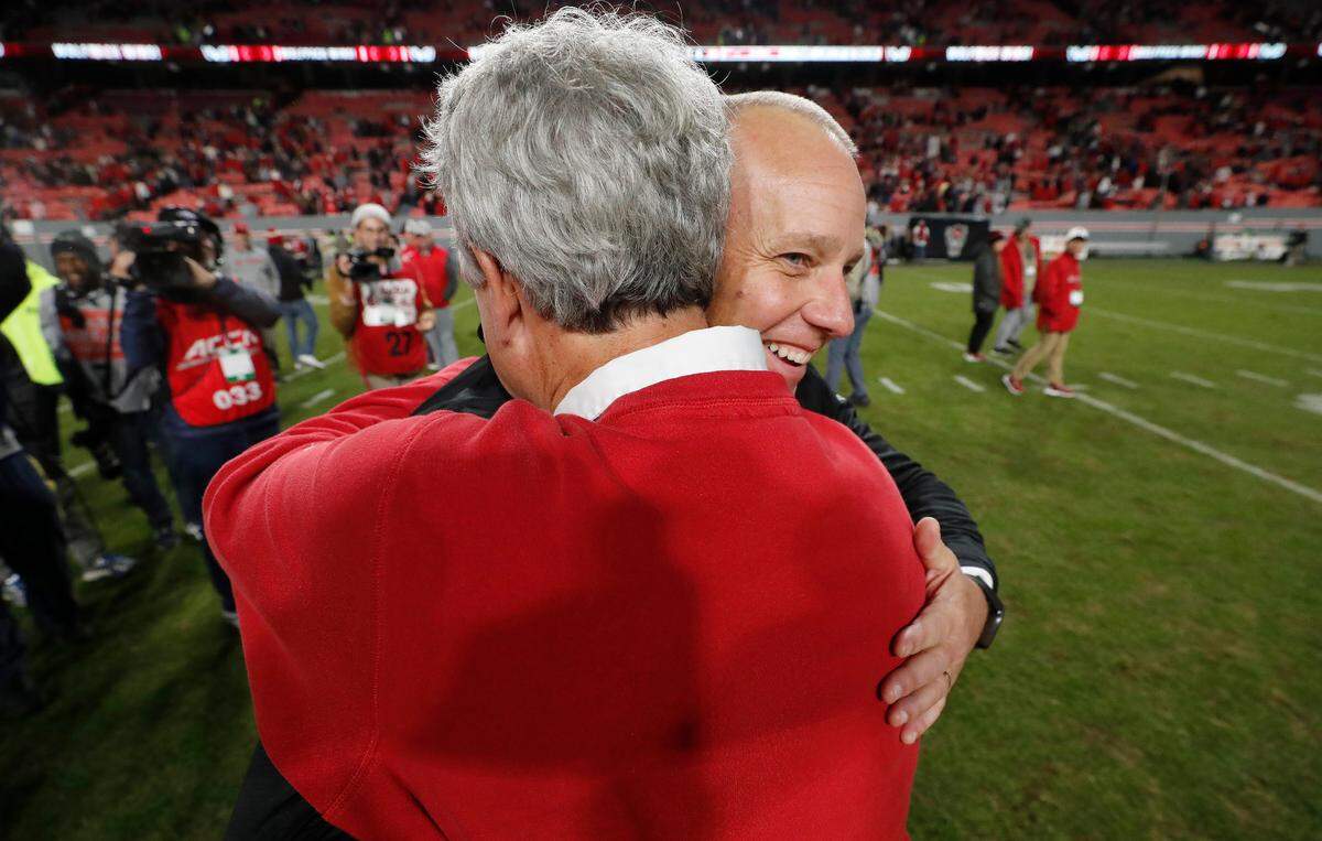 N.C. State head coach Dave Doeren gets a hug from athletics director Boo Corrigan after the Wolfpack’s 20-6 victory over Miami at Carter-Finley Stadium in Raleigh, N.C., Saturday, Nov. 4, 2023.