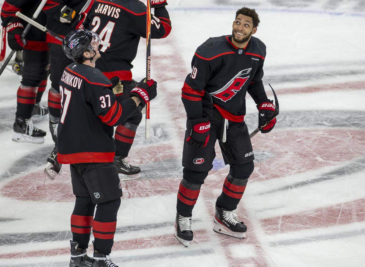 Carolina Hurricanes right wing Andrei Svechnikov (37) and defenseman K’Andre Miller (19) celebrate their victory over the Dallas Stars on Tuesday, January 6, 2026 at Lenovo Center in Raleigh, N.C.