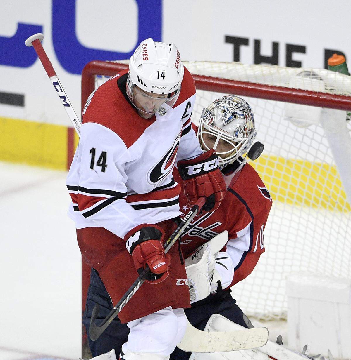 Carolina Hurricanes right wing Justin Williams (14) works for the puck against Washington Capitals goaltender Braden Holtby (70) during the third period of Game 1 of an NHL hockey first-round playoff series Thursday, April 11, 2019, in Washington. The Capitals won 4-2. (AP Photo/Nick Wass)
