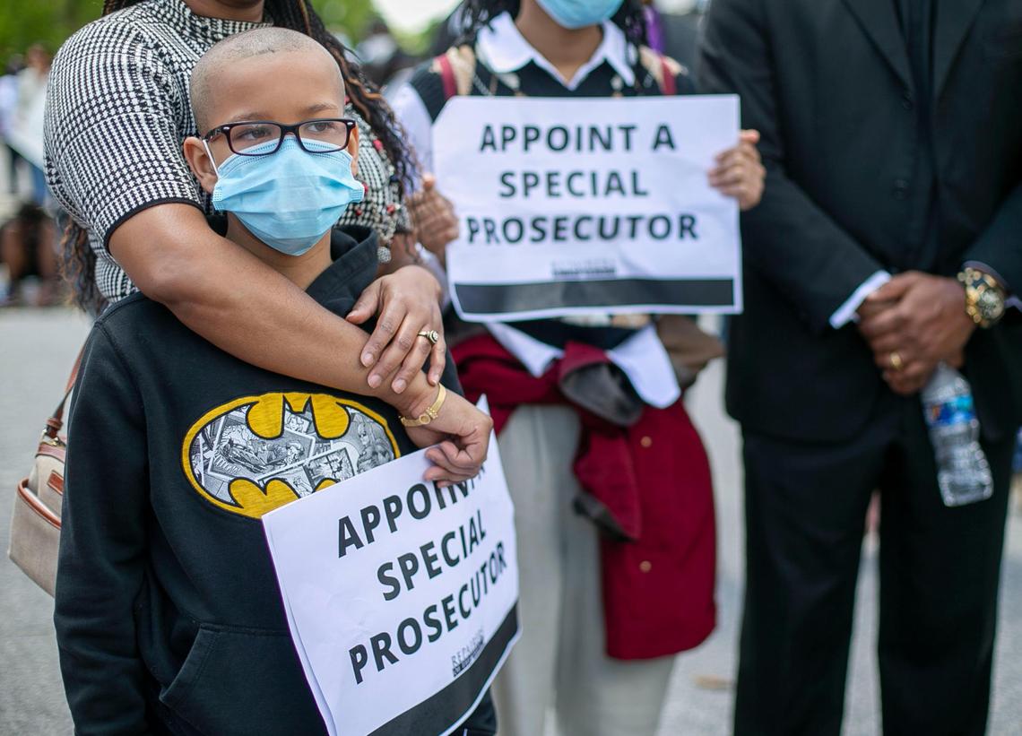 Robin Parker of holds her nine-year-old stepson Miracle Parker Jr. during a rally demanding transparency and accountability in the death of Andrew Brown Jr. on Saturday, May 8, 2021 in Elizabeth City, N.C.