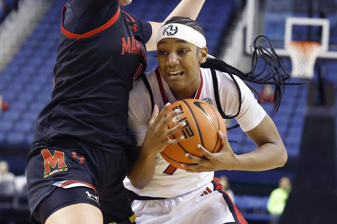 N.C. State's Destiny Lunan (7) goes around Maryland's Lea Bartelme (1) during an exhibition game against Maryland in October 2025.