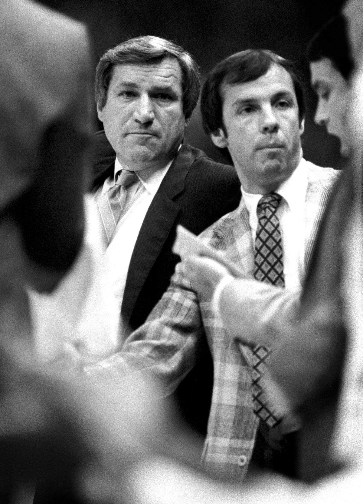 UNC coach Dean Smith with a young assistant coach Roy Williams during a 1979 game in Carmaichel Auditorium in Chapel Hill, NC.