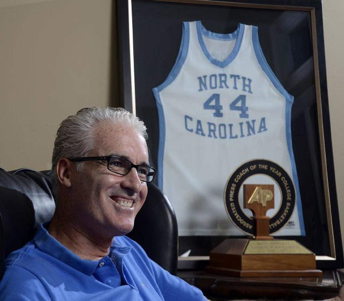 Former UNC and SMU basketball coach Matt Doherty talks in his home studio with basketball trophies and mementoes. He is back in the Charlotte area and will be doing TV analysis this season.  