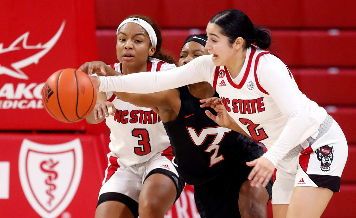 N.C. State’s Kai Crutchfield (3), left and Raina Perez (2) take the rebound from Virginia Tech’s Aisha Sheppard (2) during the second half of N.C. State’s 89-87 victory over Virginia Tech at Reynolds Coliseum in Raleigh, N.C., Sunday, January 24, 2021.