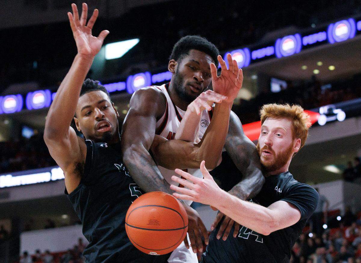 N.C. State’s Brandon Huntley-Hatfield battles for a rebound with William & Mary’s Noah Collier and Keller Boothby during the first half of the Wolfpack’s game at Lenovo Center on Friday, Nov. 22, 2024, in Raleigh, N.C.