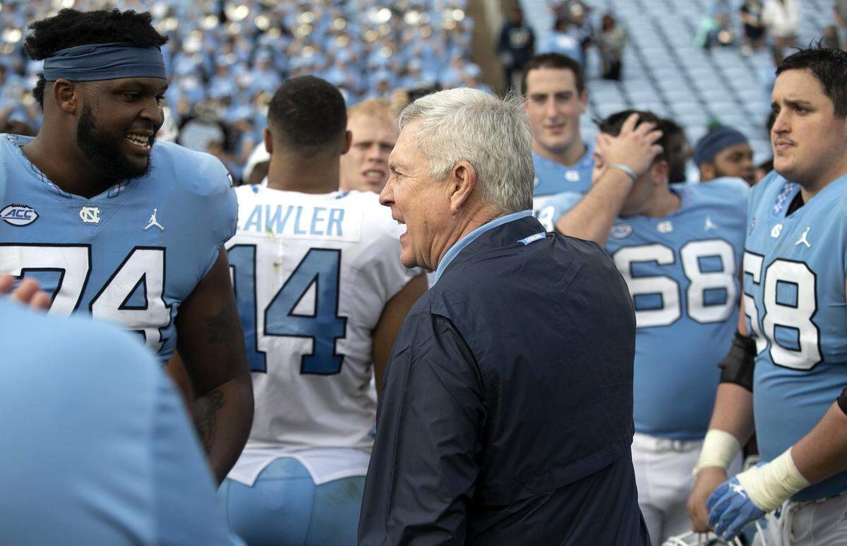 North Carolina coach Mack Brown talks with Jordan Tucker (74) following the Tar Heels’ spring football game on Saturday, April 13, 2019 at Kenan Stadium in Chapel Hill, N.C.