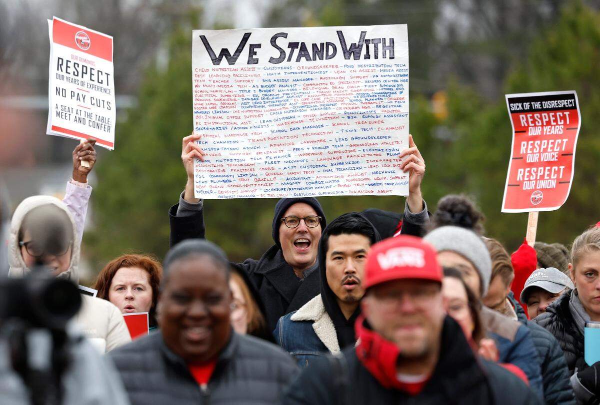 Greg Stivland, an occupational therapist ad Forest View Elementary and Jordan High School, cheers during a rally at Durham Public Schools Staff Development Center in Durham, N.C., Wednesday, Jan. 31, 2024. Some Durham public schools were closed Wednesday as staff — furious about unresolved salary issues — called in sick to attend protests.