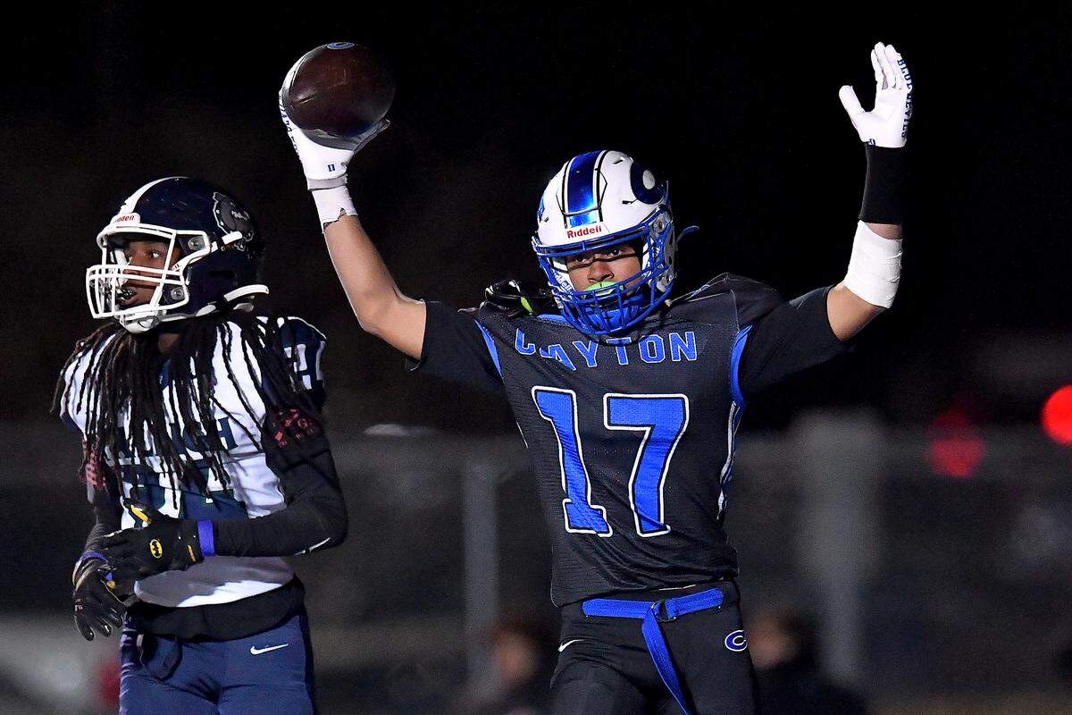 Clayton running back Parker Ferguson (17) celebrates after making his touchdown against Southeast Raleigh defensive back  Mike Rowland (24) during the second half. The Clayton Comets and the Southeast Raleigh Bulldogs met in the fourth round of the NCHSAA 7A Playoffs in Clayton, N.C. on November 28, 2025.