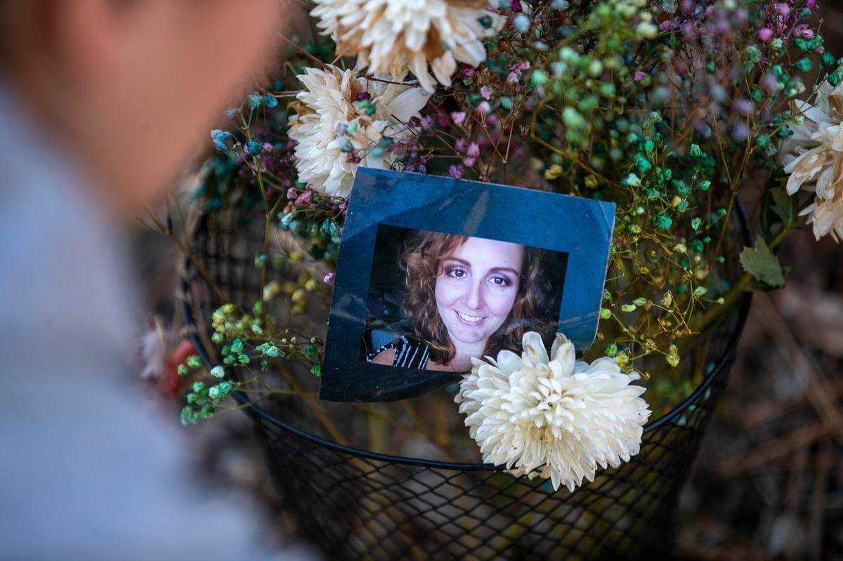 Corrinna Hodges organizes a memorial to her friend Mary Marshall along the Neuse River Greenway on Friday, January 13, 2023, in Raleigh, N.C., ninety days after Marshall lost her life during the mass shooting in the Hedingham neighborhood.  