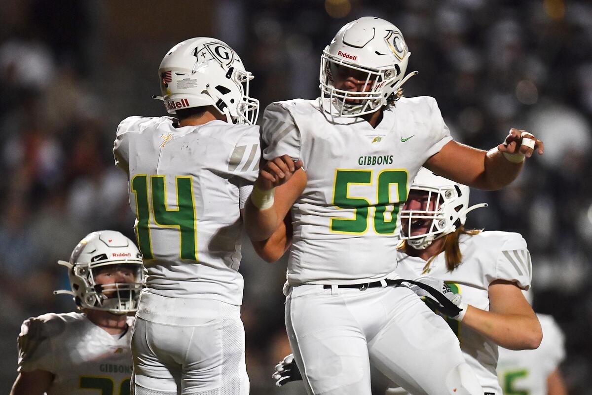 Cardinal Gibbons’ Pierce Johnston (50) celebrates with Chet Yardley (14) after his touchdown run in the first half. The Leesville Road Pride and the Cardinal Gibbons Crusaders met in a football game in Raleigh, N.C. on October 7, 2022.