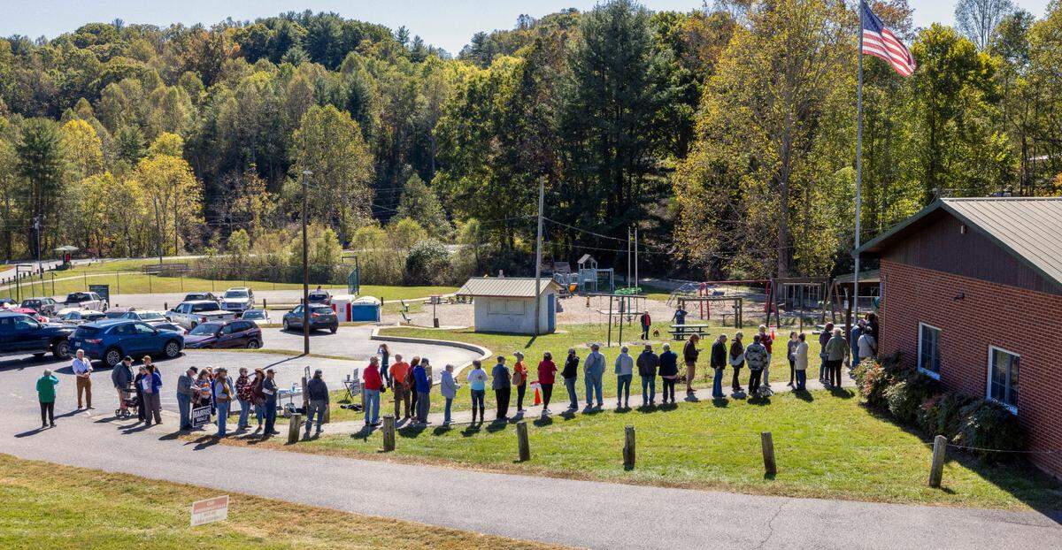 Voters wait in line to cast their ballots on the first day of early voting, on Thursday, October 17, 2024, at the Leicester Community Center in Leicester, N.C.