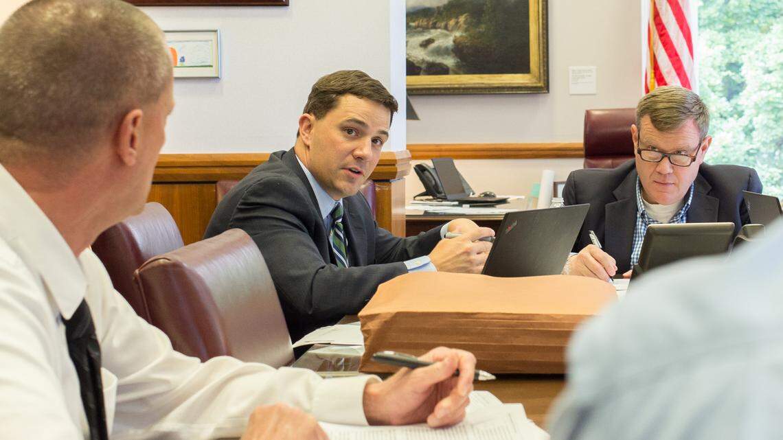 Jim Blaine, center, Senate leader Phil Berger’s chief of staff, discusses budget priorities with House Speaker Tim Moore and staffers of the North Carolina General Assembly on Friday, May 25, 2018.