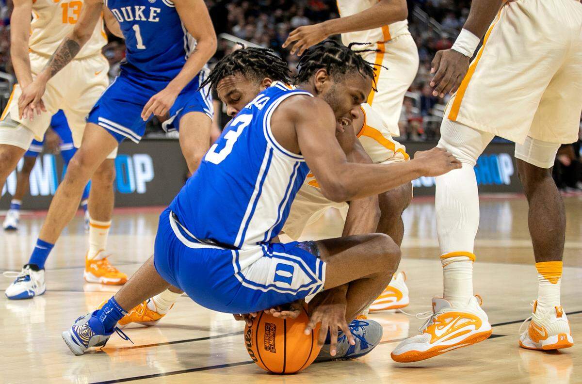 Duke’s Jeremy Roach (3) and Tennessee’s Josiah-Jordan James (30) battle for a loose ball in the first half during the second round of the NCAA Tournament on Saturday, March 18, 2023 at the Amway Center in Orlando, Fla.