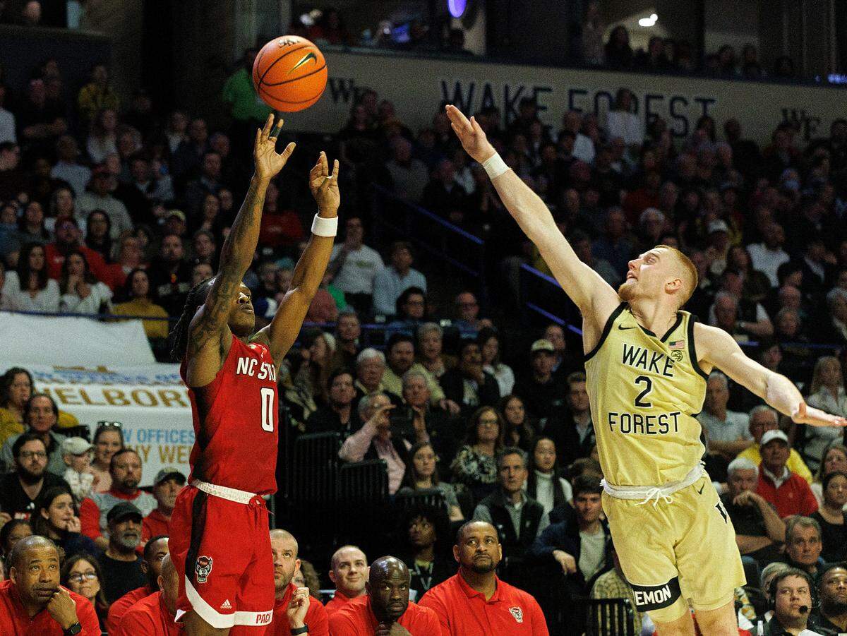 N.C. State’s DJ Horne shoots over Wake Forest’s Cameron Hildreth during the second half of the Wolfpack’s 83-79 loss on Saturday, Feb. 10, 2024, at Lawrence Joel Veterans Memorial Coliseum in Winston-Salem, N.C.