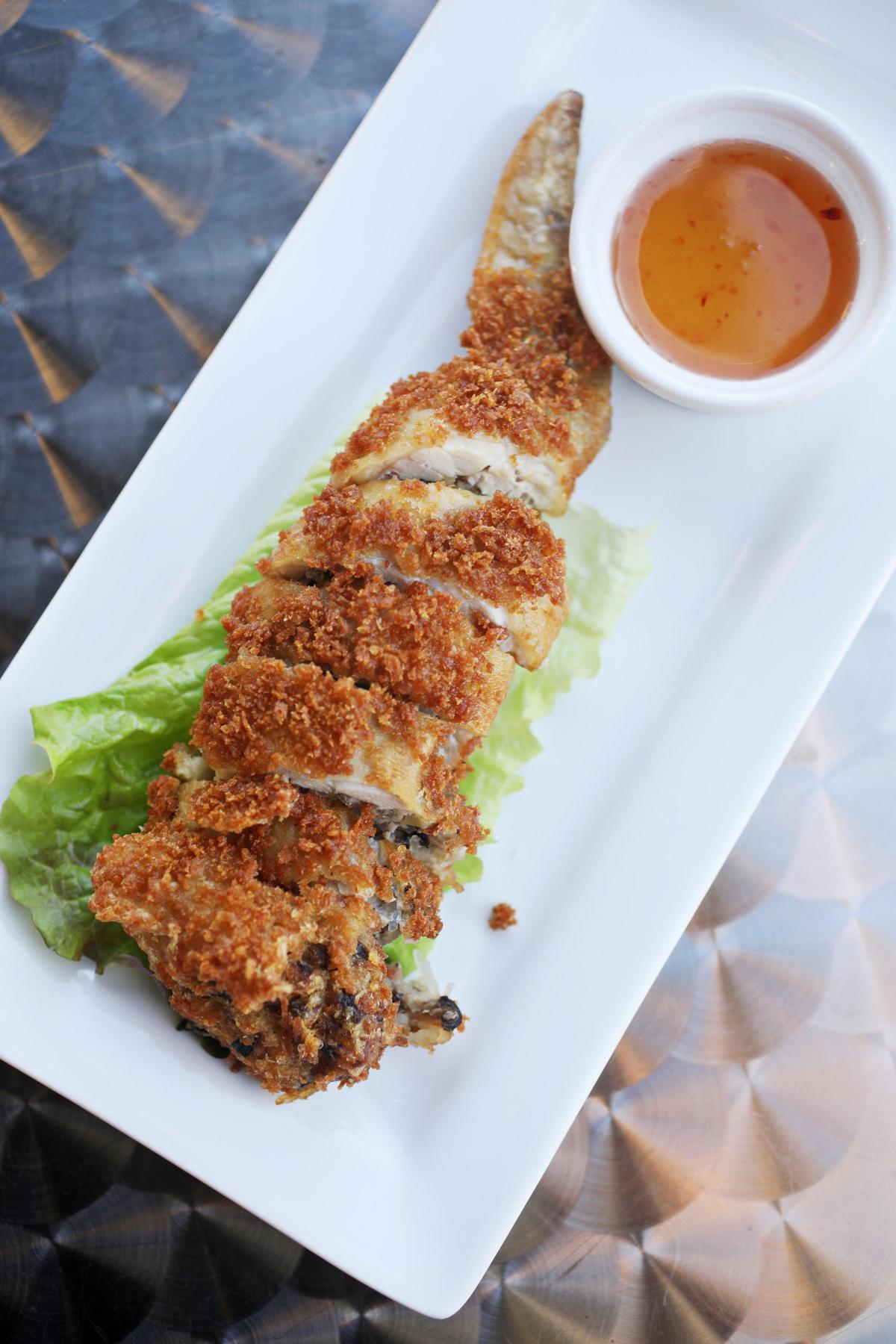 The Thai angel wing is a single jumbo wing, deboned and stuffed with a savory hash of ground pork, glass noodles, mushroom, carrot and onion, rolled in panko and fried to a crisp golden turn at Thai 54.
