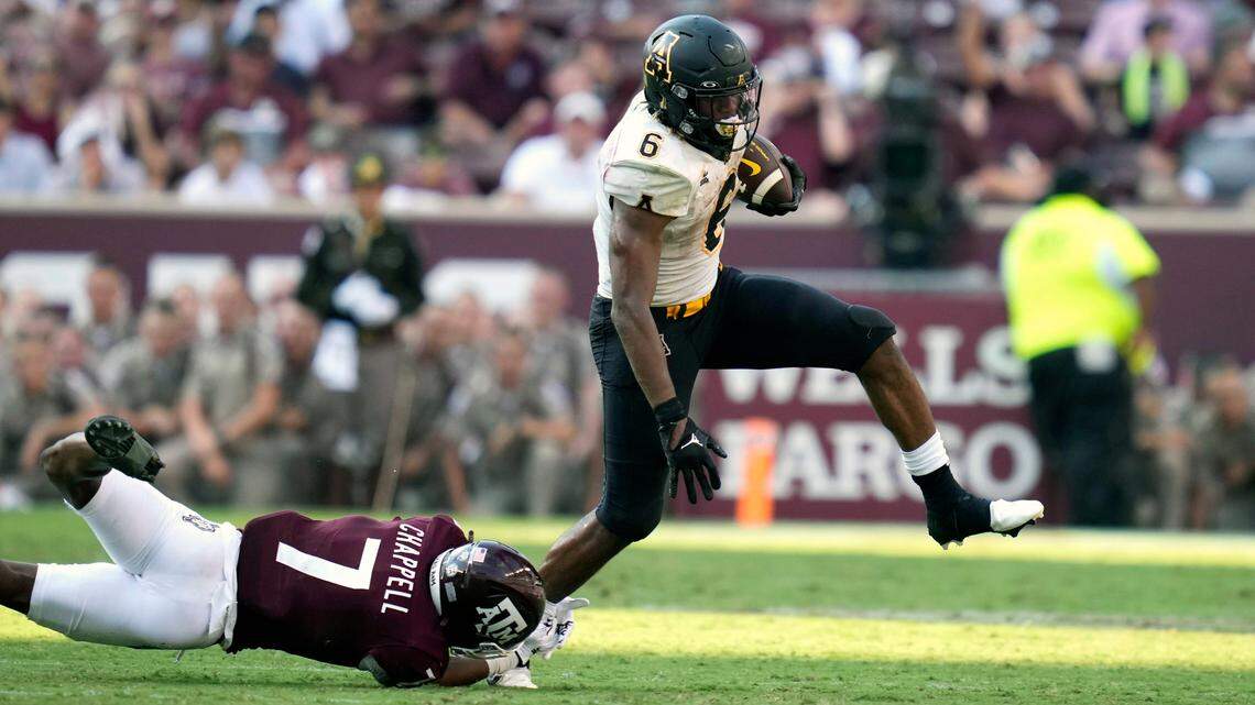 Appalachian State running back Camerun Peoples (6) steps out of a tackle by Texas A&M defensive back Tyreek Chappell (7) for a first down run nearing the end of the fourth quarter during an NCAA college football game Saturday, Sept. 10, 2022, in College Station, Texas.