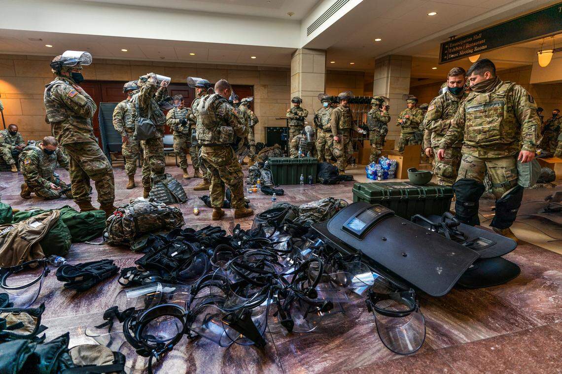 Members of the National Guard gather inside the Capitol Visitor Center, Wednesday, Jan. 13, 2021, in Washington as the House of Representatives continues with its fast-moving House vote to impeach President Donald Trump, a week after a mob of Trump supporters stormed the U.S. Capitol.