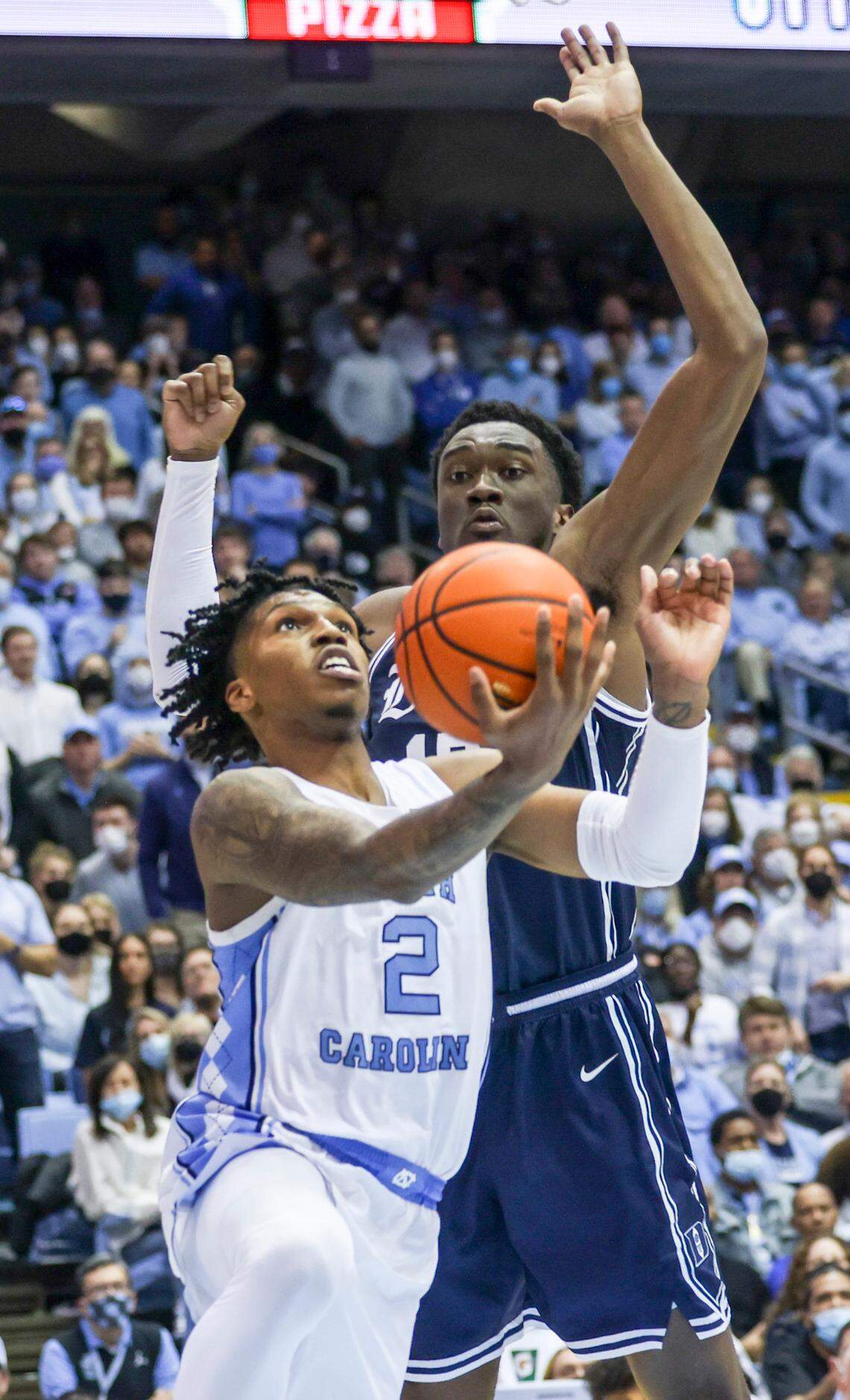 North Carolina’s Caleb Love (2) drives to the net as Dukes Mark Williams (15) defends during the second half of UNC’s game against Duke Saturday, Feb. 5, 2022 at the Dean Smith Center. Duke won 87-67.