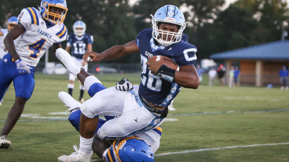 Cleveland running back Omarion Hampton (28) dives forward for extra yardage after a long run featuring numerous broken tackles during the Garner Trojans’ football game at the Cleveland Rams on Friday, August 30, 2019.