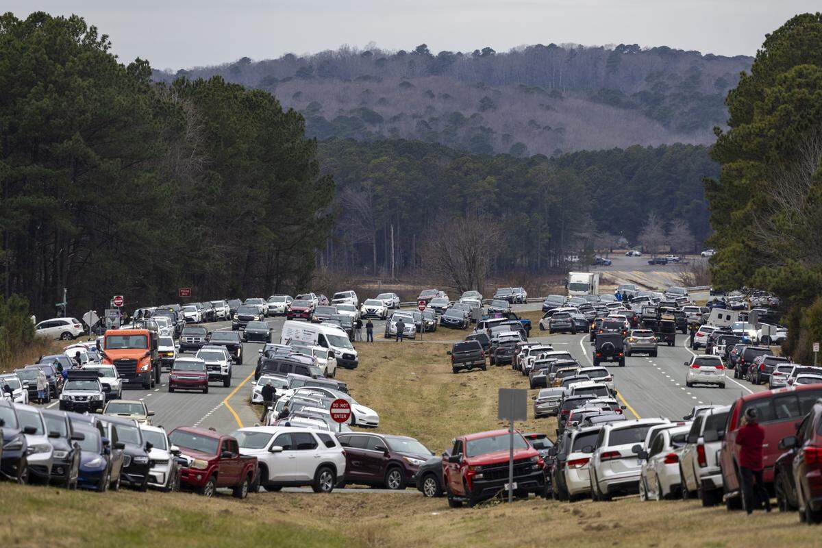 Hundreds of vehicles are parked along U.S. Highway 64 Jordan Lake in Chatham County on Friday, Jan. 23, 2026, as thousands of onlookers wait to catch a view of Buddhist monks on a 2,300-mile pilgrimage from Texas to Washington, D.C., as part of the “Walk for Peace,” an effort to promote peace, compassion and national unity.