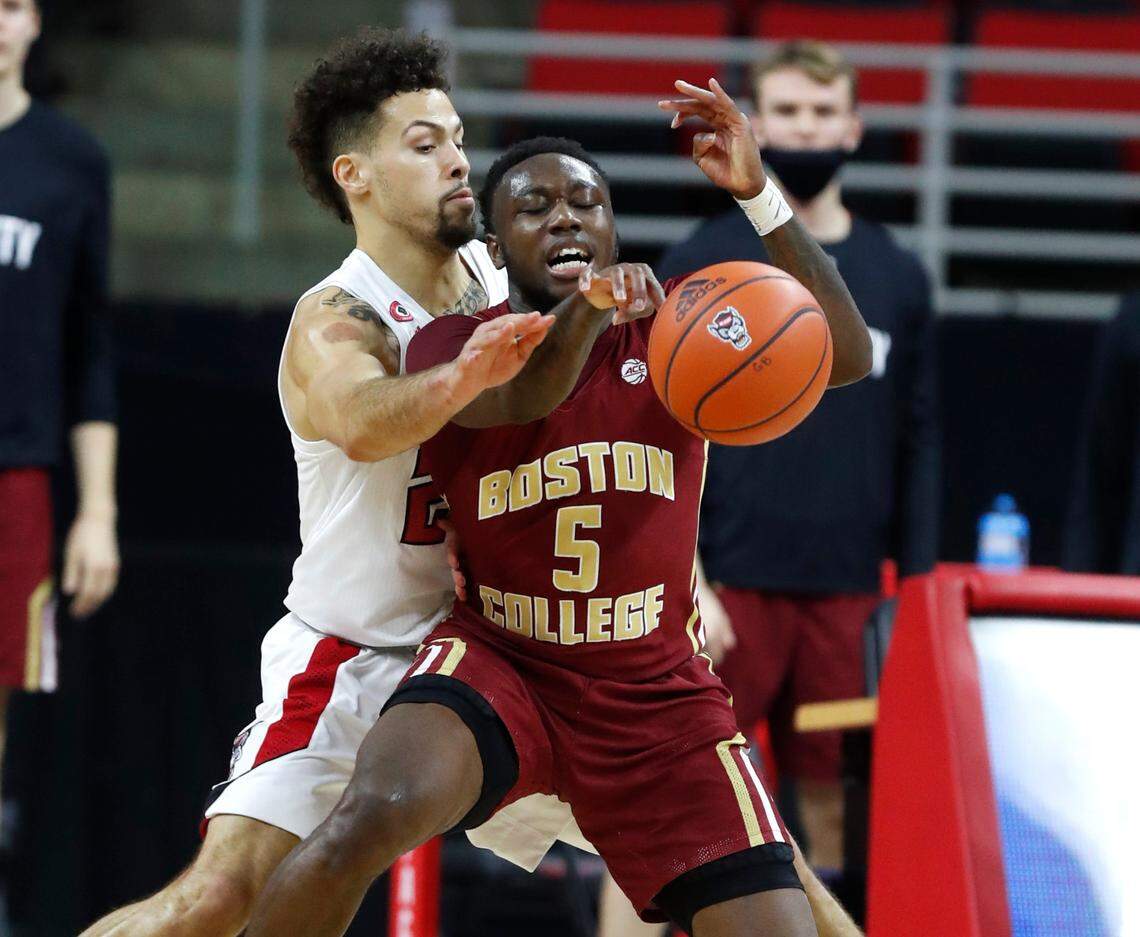 N.C. State’s Devon Daniels (24) pressures Boston College’s Jay Heath (5) during the second half of N.C. State’s 79-76 victory over Boston College at PNC Arena in Raleigh, N.C., Wednesday, December 30, 2020.