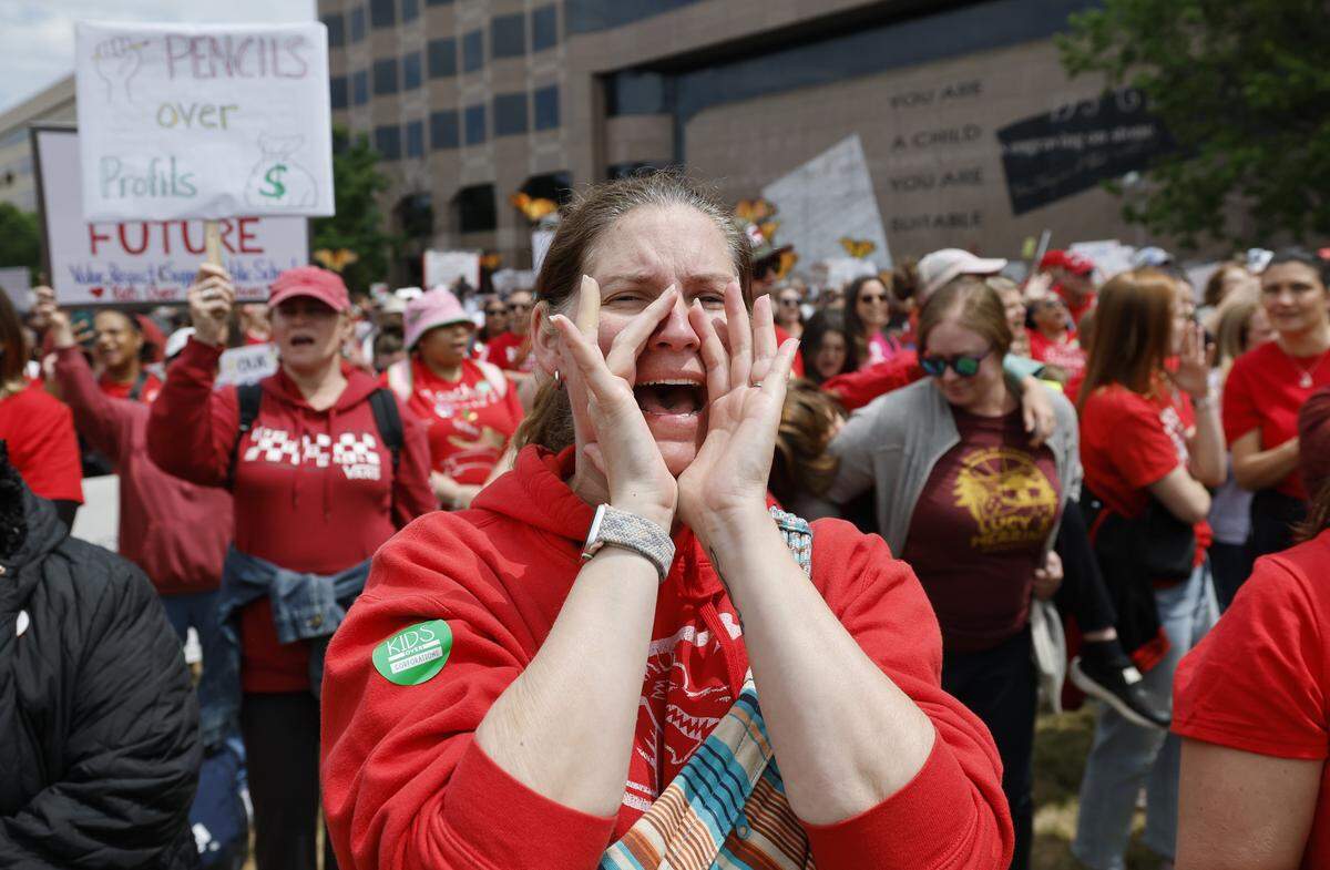 Natalee Fiery, a teacher at McDougle Elementary School in Carrboro, cheers on the speakers during a rally to protest for more school funding at Halifax Mall in downtown Raleigh, N.C., Friday, May 1, 2026.  The North Carolina Association of Educators has mobilized teachers from across the state to march on the Legislative Building to demand higher pay, more school funding and higher taxes on corporations. 