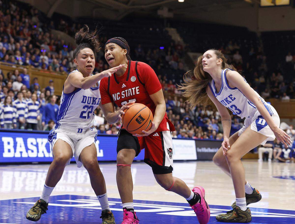 N.C. State’s Zoe Brooks drives past Duke’s Taina Mair and Jordan Wood during the first half of the Wolfpack’s game on Thursday, Feb. 19, 2026, at Cameron Indoor Stadium in Durham, N.C.