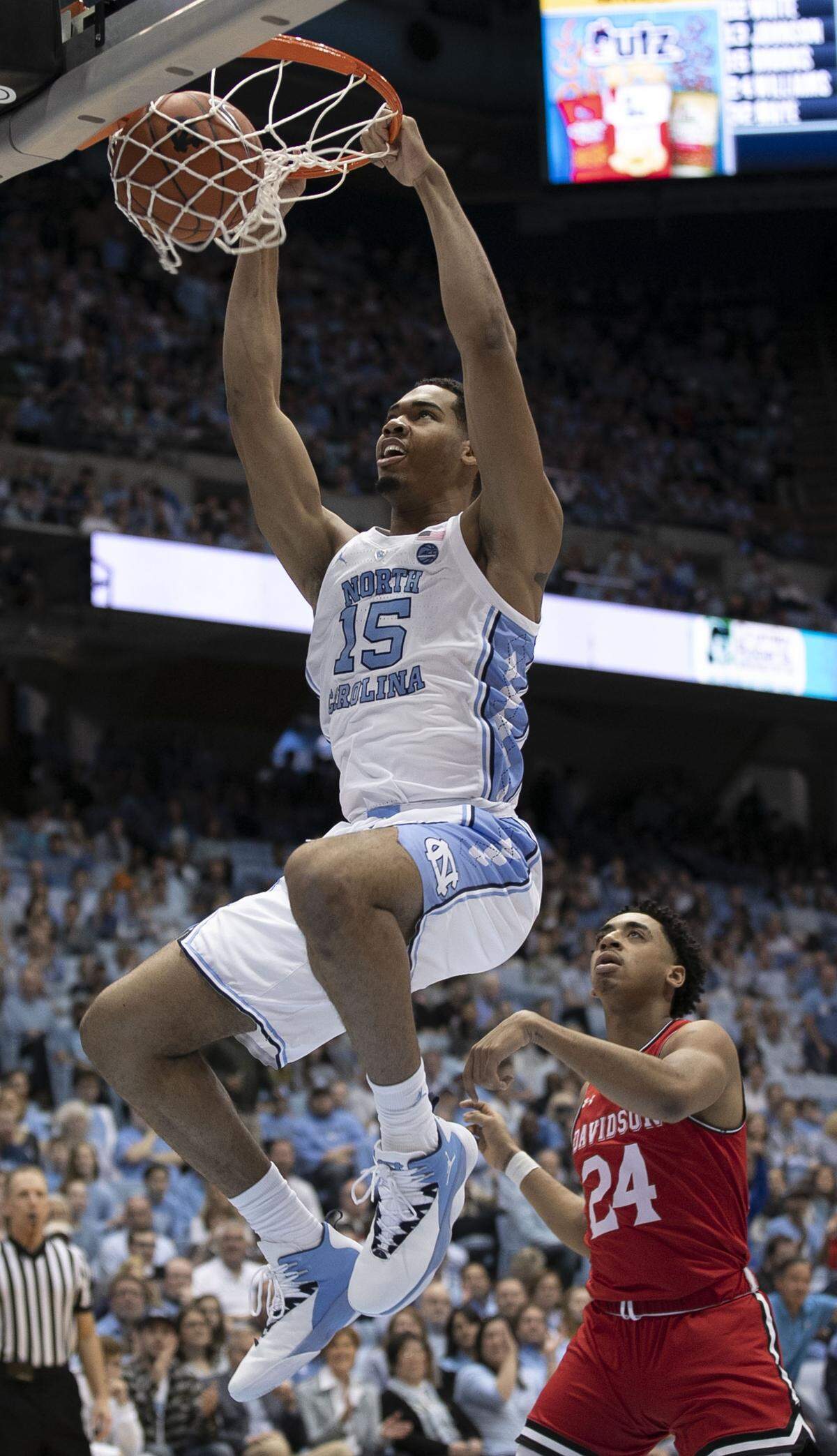 North Carolina’s Garrison Brooks (15) dunks over Davidson’s Carter Collins (24) in the first half on Saturday, December 29, 2018 at the Smith Center in Chapel Hill, N.C.