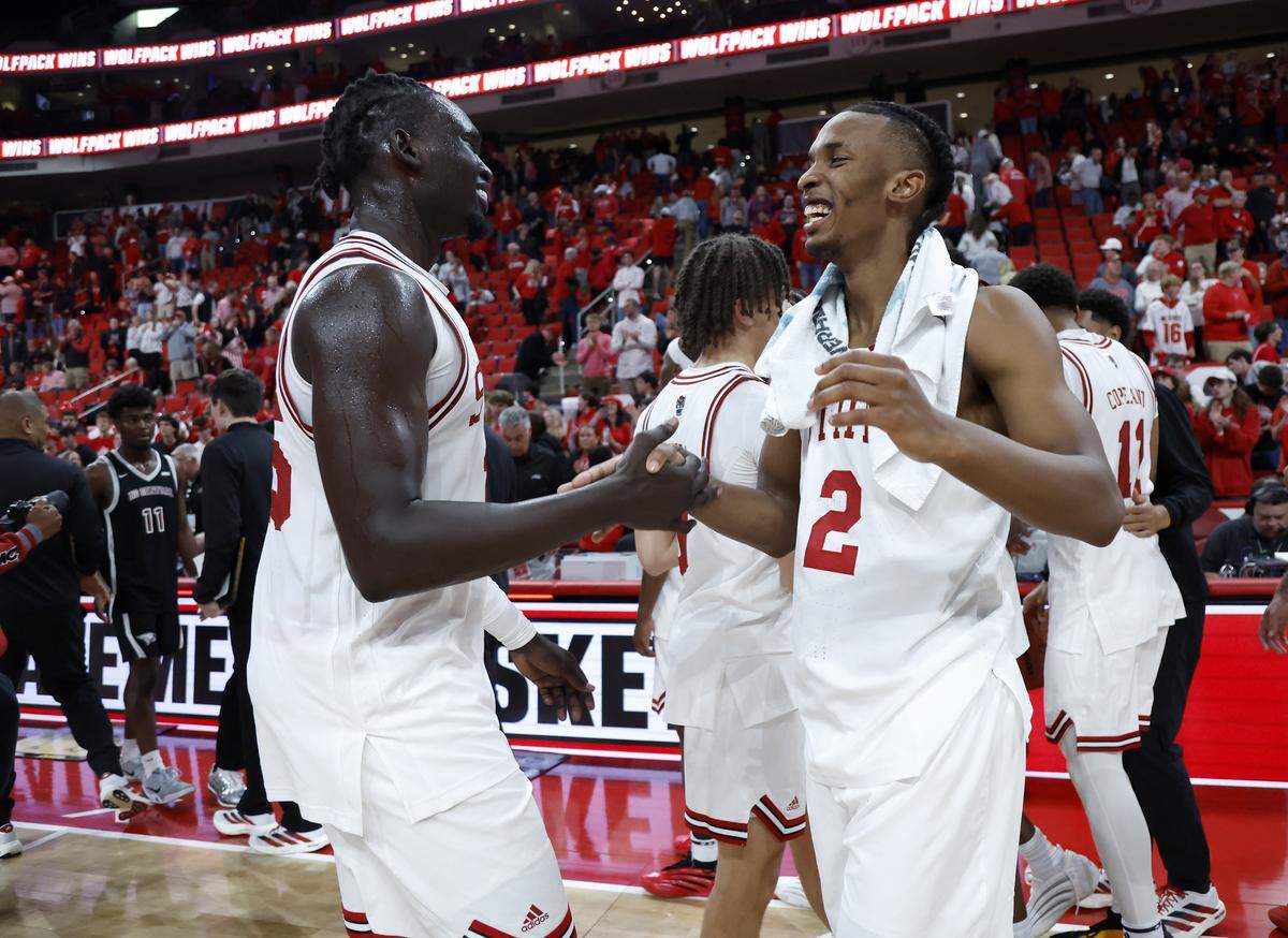 N.C. State’s Jerry Deng and Paul McNeil Jr. high five at the conclusion of the Wolfpack’s 114-66 win over North Carolina Central at Lenovo Center on Monday, Nov. 3, 2025, in Raleigh, N.C.