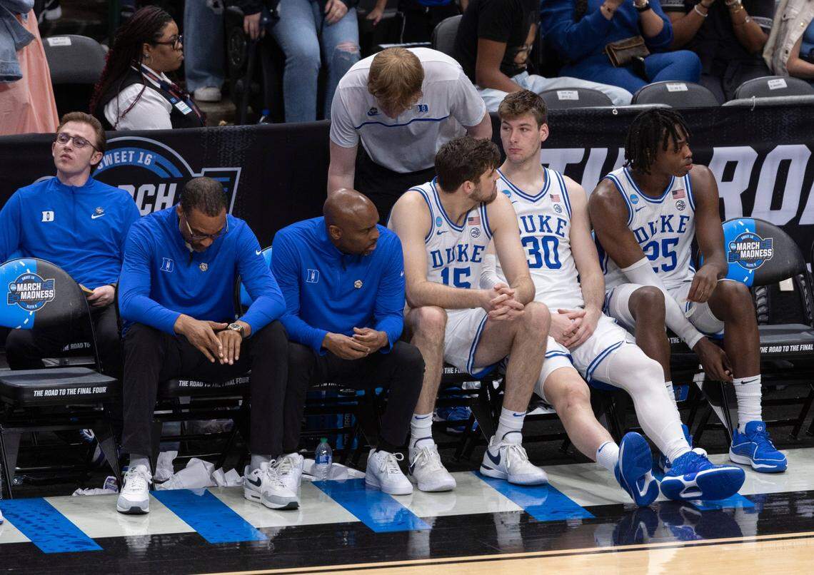 Duke’s Ryan Young (15), Kyle Filipowski (30) and Mark Mitchell (25), sit quietly on the bench following their 76-64 loss to N.C. State in the NCAA South Regional final on Sunday, March 31, 2024 at the American Airlines Center in Dallas, Texas.