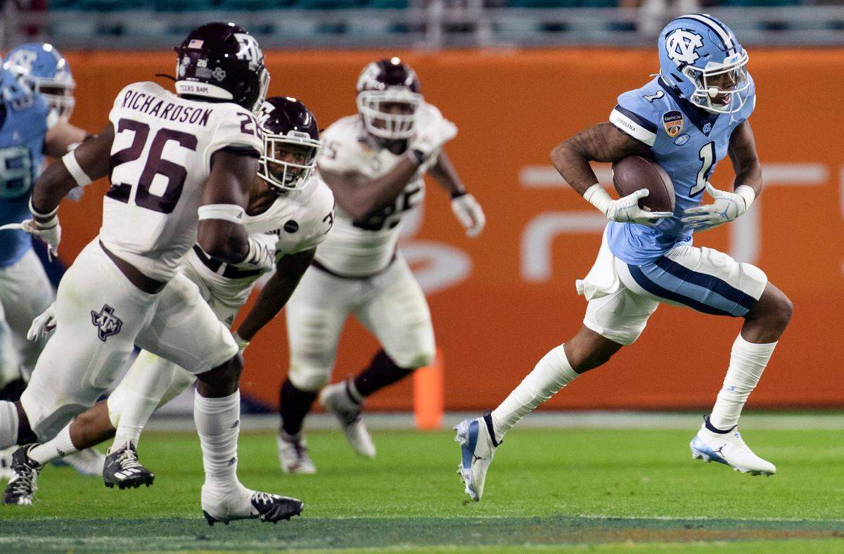 North Carolina’s Khafre Brown (1) picks up 26-yard on a pass reception from quarterback Sam Howell in the third quarter during the Capital One Orange Bowl on Saturday, January 2, 2021in Miami Gardens, Florida. 