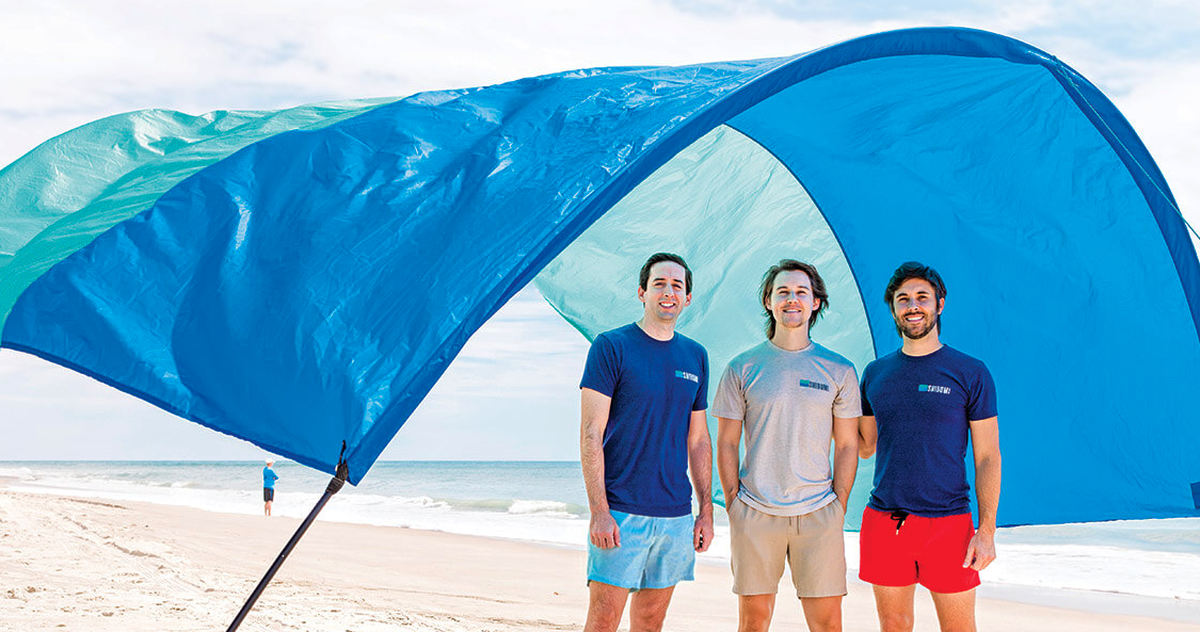 Alex Slater, left, and brothers Scott and Dane Barnes, all UNC grads, invented the Shibumi Shade. In response to consumer demand, they are introducing a new color combination and a quieter fabric for summer 2024.