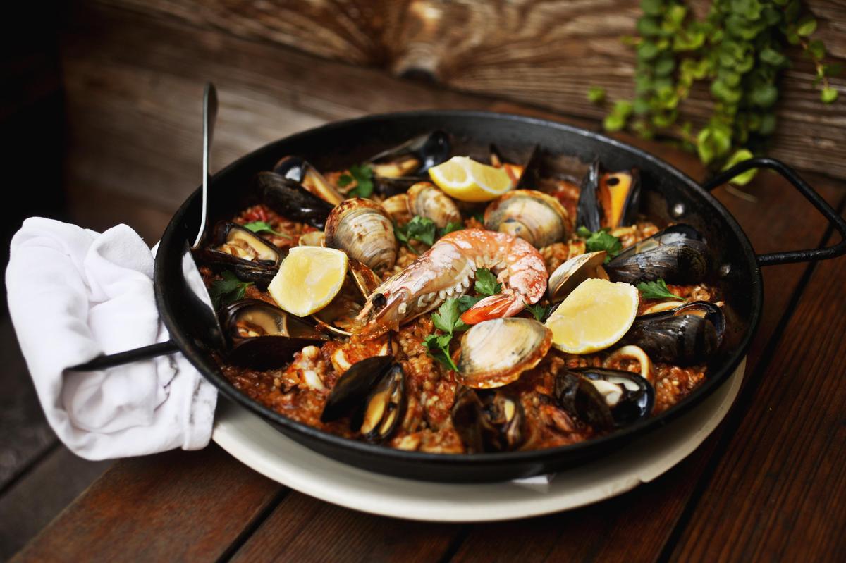 The paella mariscos for two is bristling with clams, mussels, squid and a couple of gargantuan head-on prawns at Barcelona Wine Bar in downtown Raleigh.