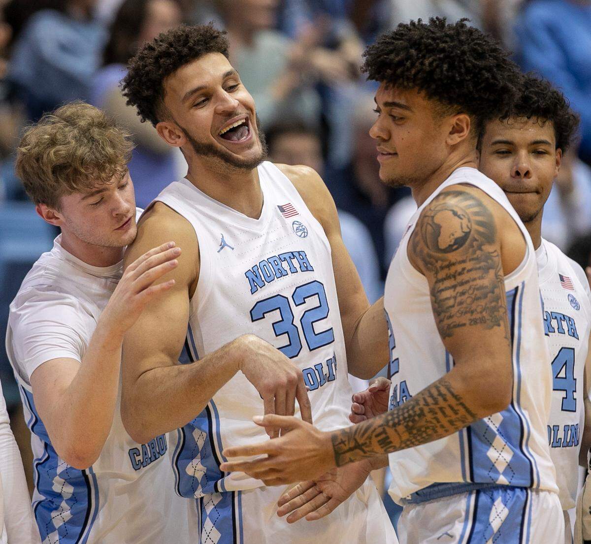 North Carolina’s Pete Nance (32) greets teammate Justin McKoy (22) after McKoy scored six points coming off the bench late in the second half against Clemson on Saturday, February 11, 2023 at the Smith Center in Chapel Hill , N.C.