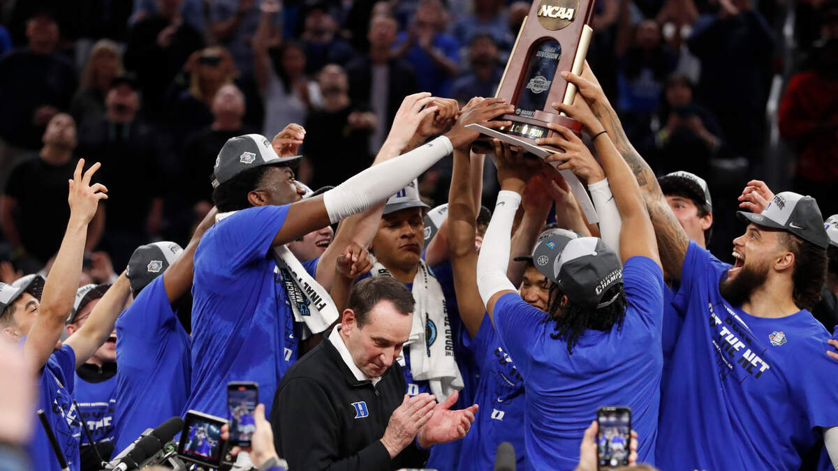 Duke players hold up the West Regional trophy after Dukeís 78-69 victory over Arkansas in the NCAA Tournament West Regional finals at the Chase Center in San Francisco, Calif., Saturday, March 26, 2022.